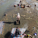 Tibetans washing in the river, Shegar, Tibet.