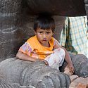 Child playing on statue, Durbar Square, Kathmandu, Nepal.
