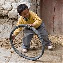 Child playing with tyre, Gyantse, Tibet.