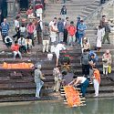 Body being purified in the Bagmati River before cremation, Nepal.